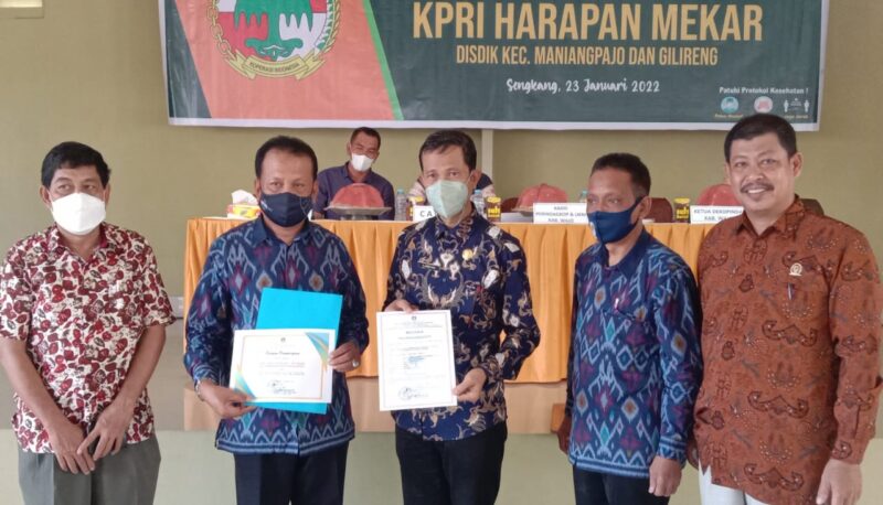 Kadis Perindakop H. Ambo Mai didampingi Ketua Dekopinda Wajo Andi Mappanyukki menyerahkan sertifikat koperasi cukup sehat dan piagam penghargaan sebagaoi koperasi tercepata melakukan RAT kepada Ketua KPRI Harapan Mekar Syamsul Bahri.--hamzah--