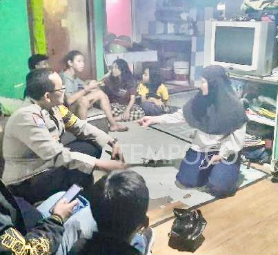 Petugas Polisi mendatangi dirumahnya  R, seorang ibu yang mencabuli anak kandungnya, di Kota Tangerang Selatan